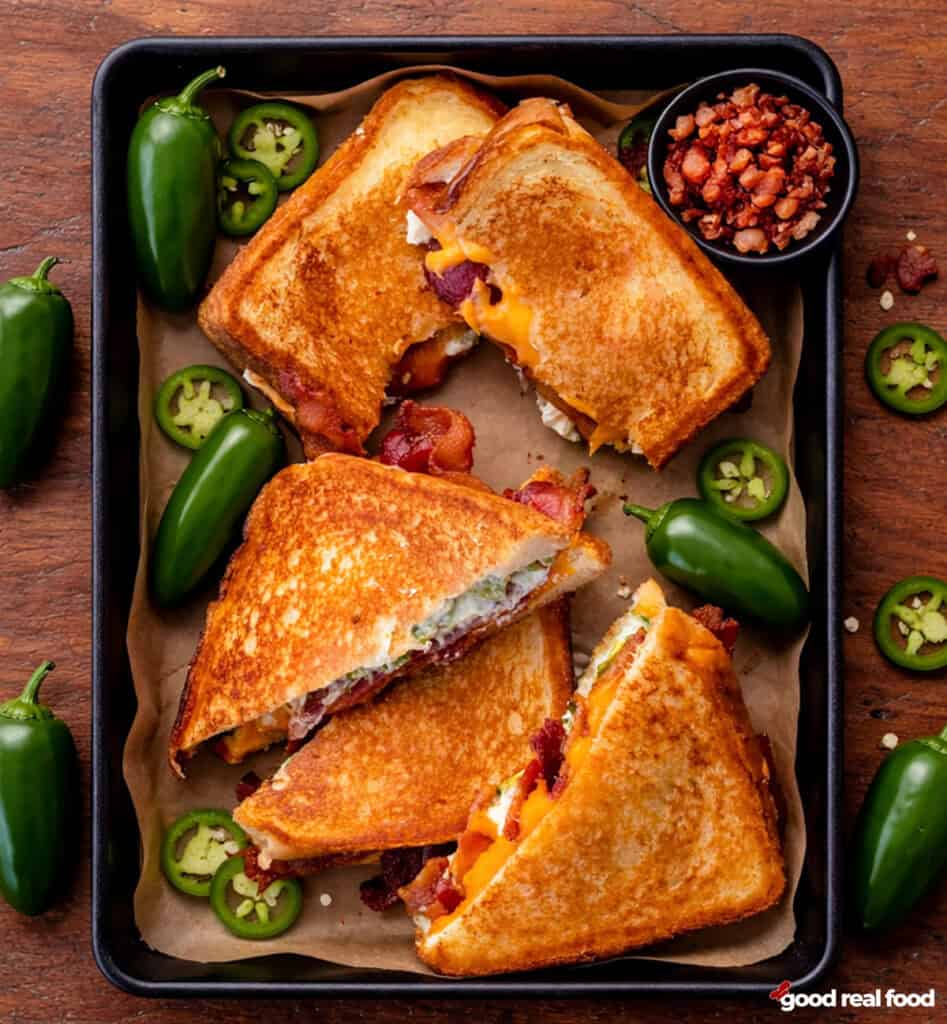 Jalapeno popper grilled cheese sandwiches in a tray.